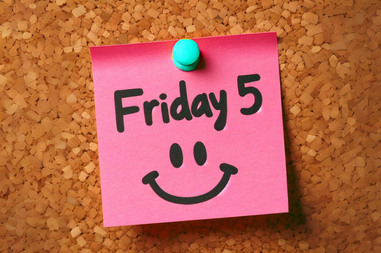 Sticky note on a corkboard with "Friday 5" and a smiley face written in marker