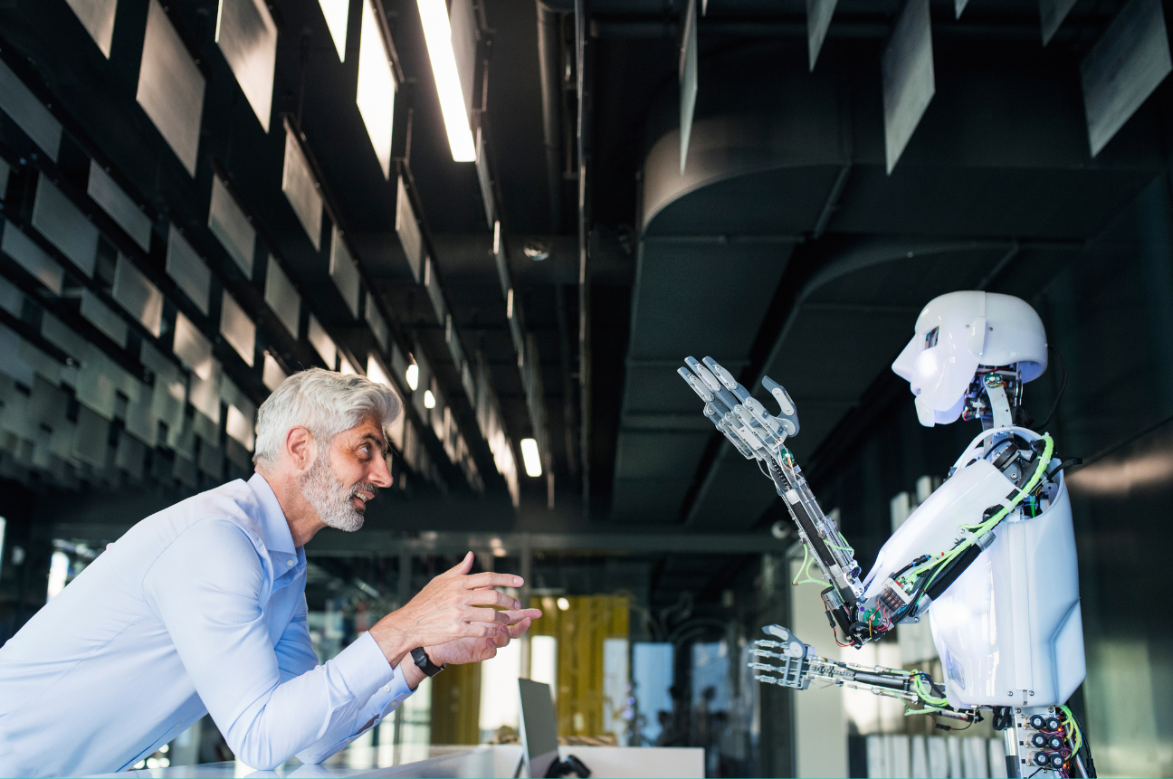 A Human and a Robot Interact, Symbolizing the Need for Human Skills in an AI-Powered Workplace