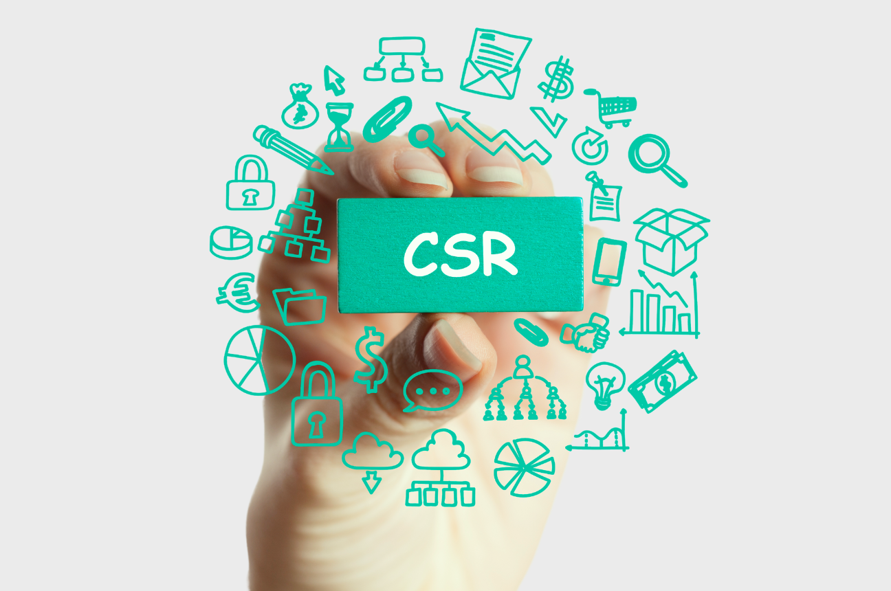 A hand holding a card that says CSR or Corporate Social Responsibility, and surrounded by various icons