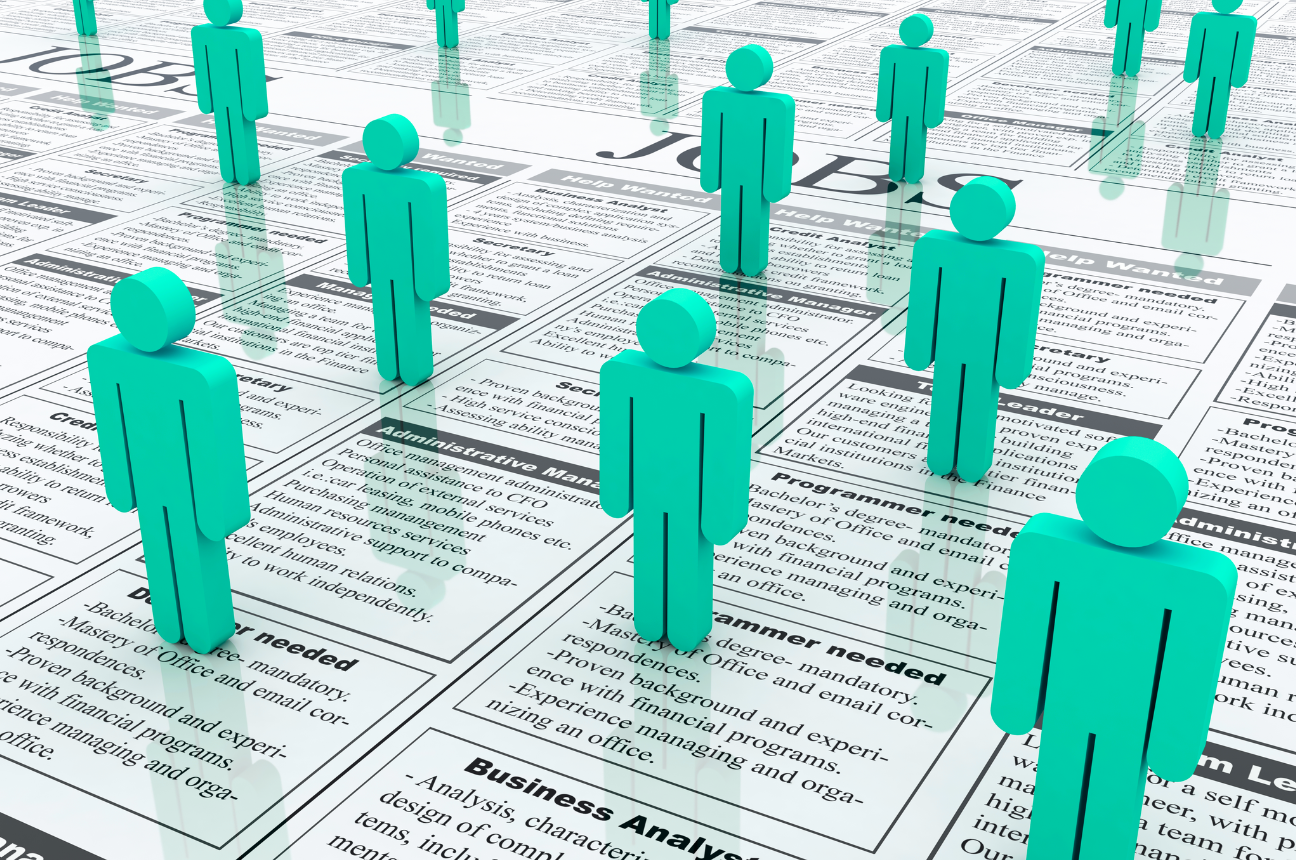 Figures standing over help wanted ads to represent the April jobs report
